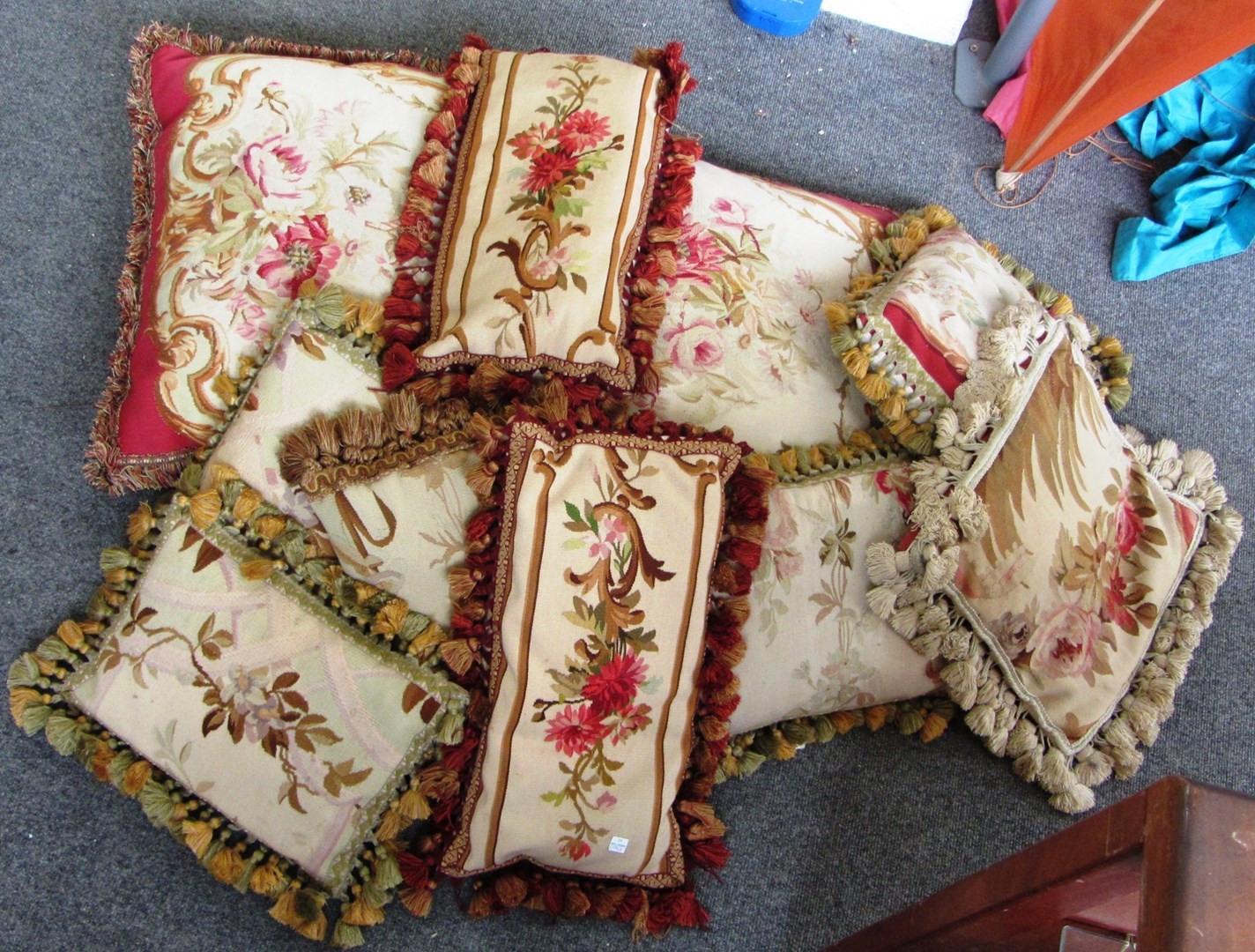 Appraisal: A quantity of floral embroidered cushions mostly with tasseled edges