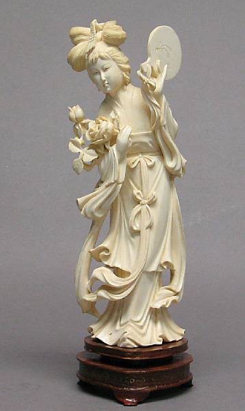 Appraisal: A carved ivory figure of a beauty holding a mirror