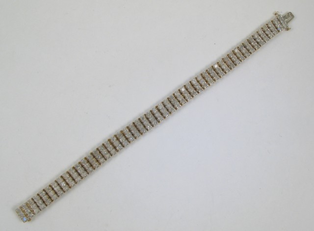 Appraisal: DIAMOND AND FOURTEEN KARAT GOLD BRACELET The triple row bracelet