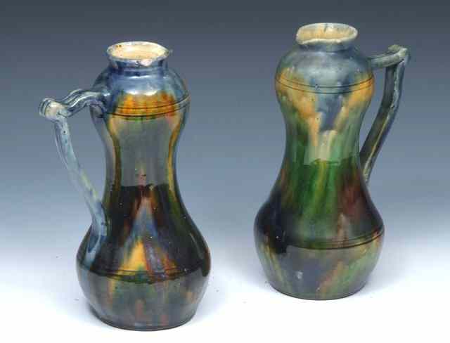 Appraisal: A PAIR OF POTTERY EWERS in the manner of Dr