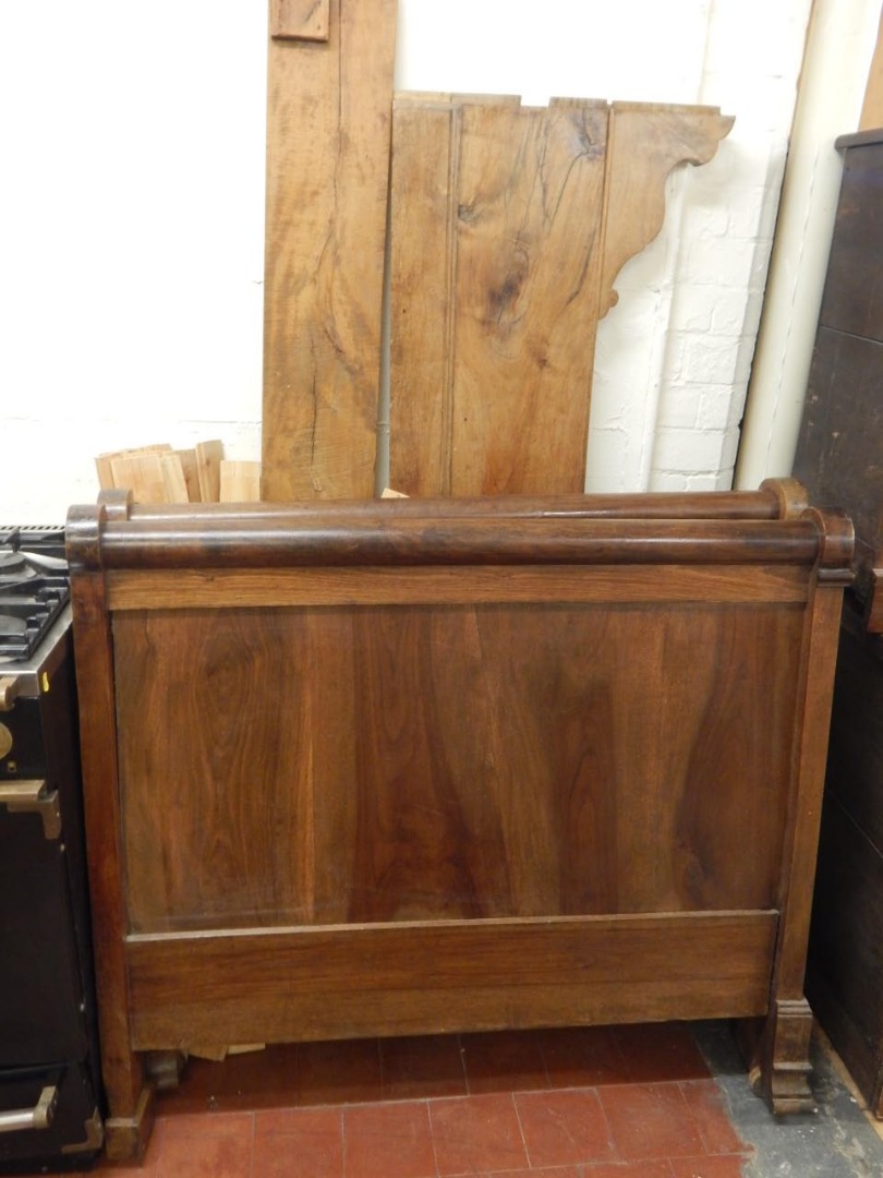 Appraisal: A French walnut sleigh type single bed head and foot