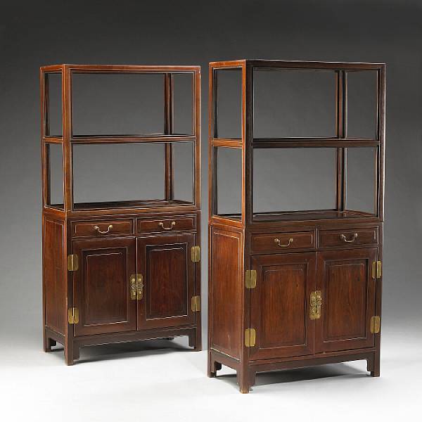 Appraisal: A pair of two-section mixed wood display and storage cabinets