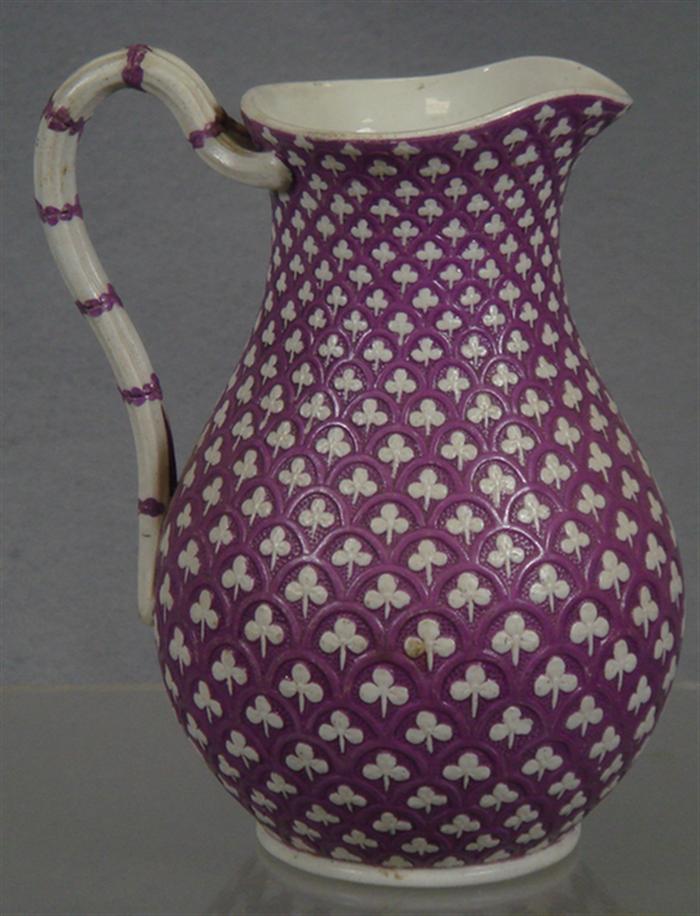 Appraisal: English earthenware pitcher with clover decoration on a plum color