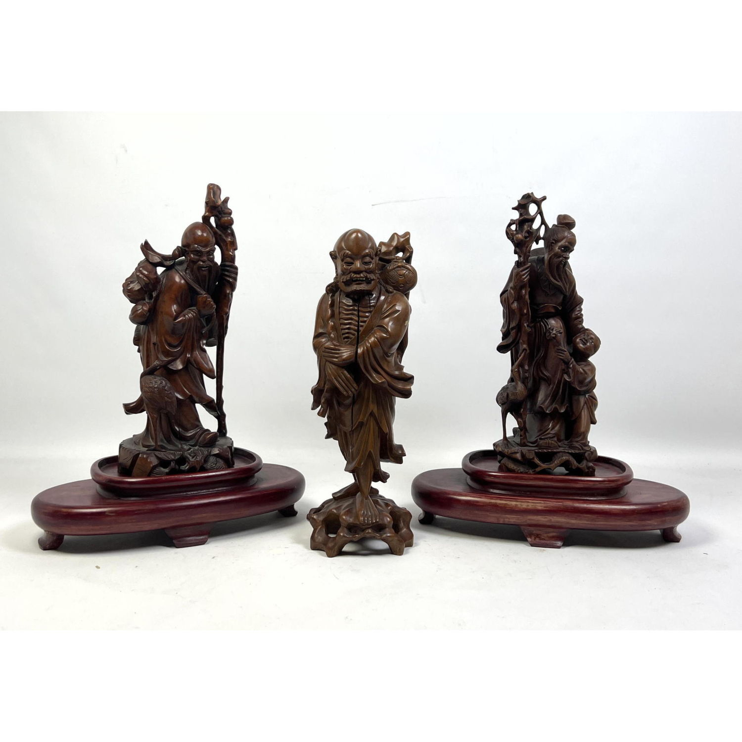 Appraisal: pc Carved Wood Asian Figures Two Wise Elders with staffs