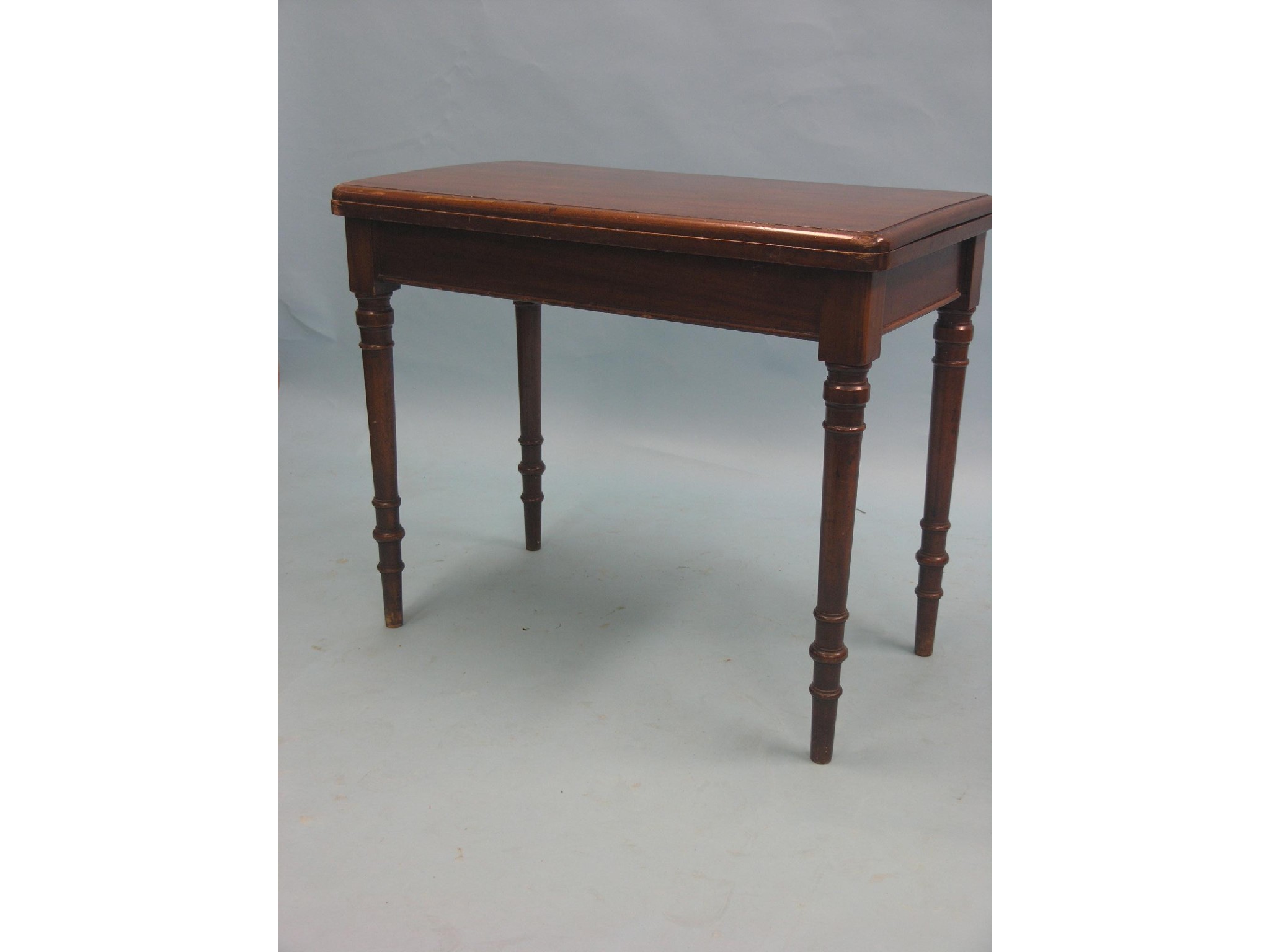 Appraisal: A Victorian mahogany card table rectangular-shape with enclosed baize lining