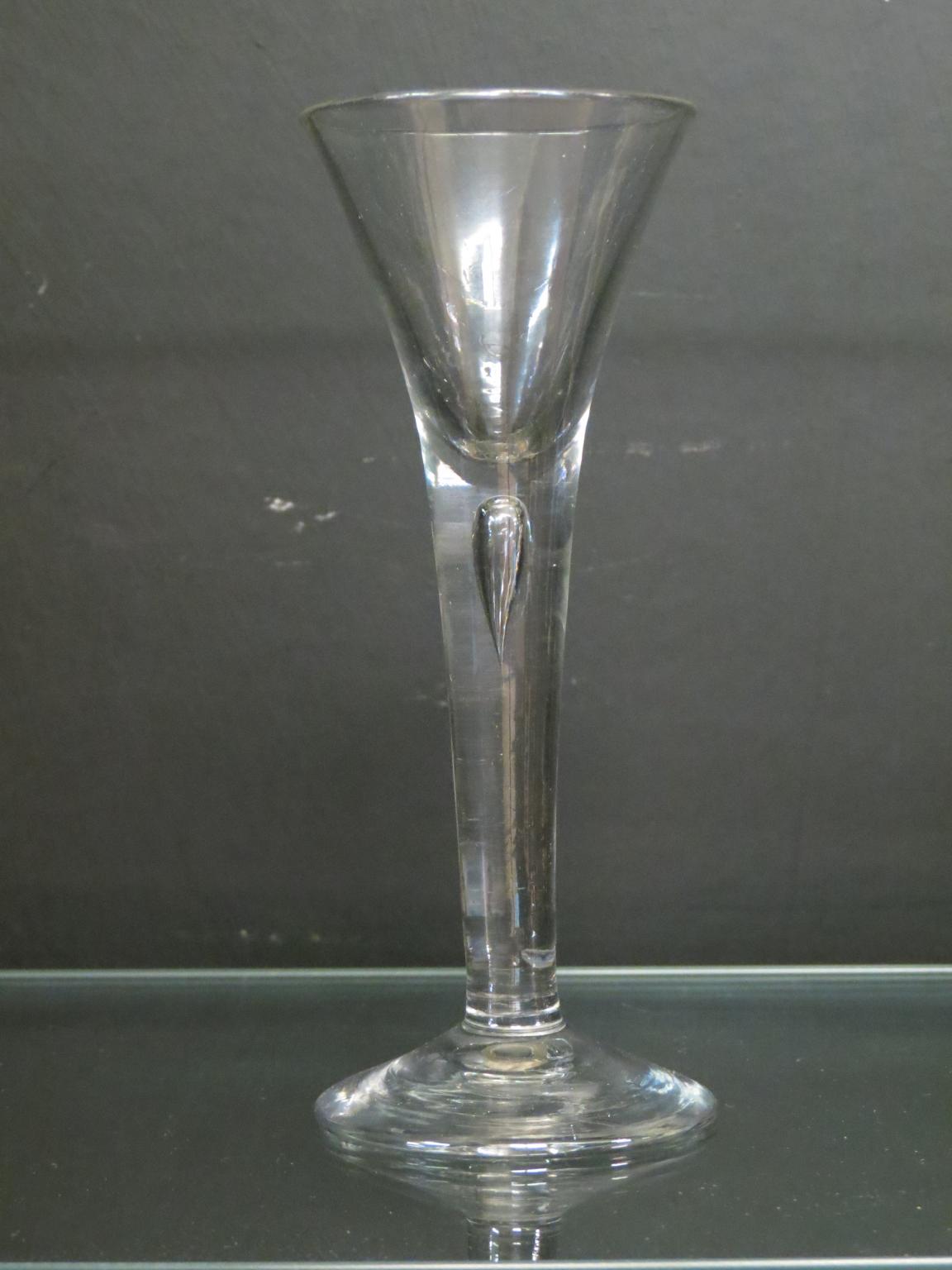 Appraisal: An th century English cordial glass drawn-trumpet form with single