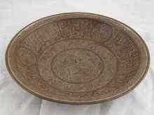 Appraisal: A heavy copper bowl with incised Islamic script and flora