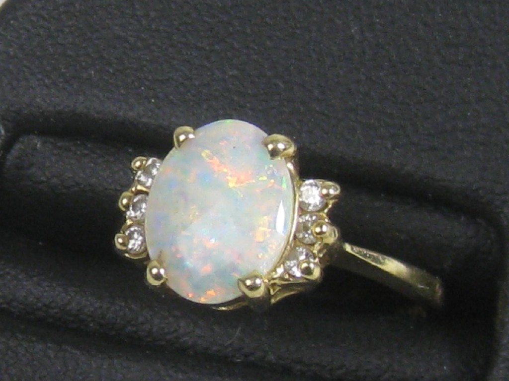 Appraisal: An Opal and Diamond Ring the oval opal cabochon claw-set