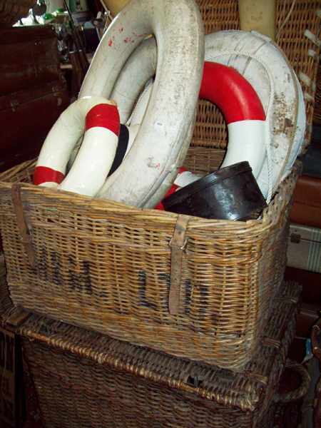 Appraisal: TWO LARGE CANE TRAVELLING TRUNKS A COLLECTION OF BUOYS A