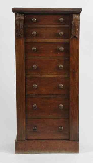 Appraisal: A Victorian stained beechwood Wellington chest of seven drawers within