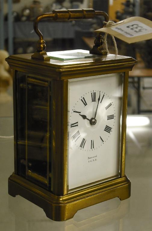 Appraisal: Unusual French double sided carriage timepiece within a corniche brass