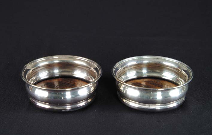 Appraisal: PAIR OF SILVER PLATED AND WOOD WINE COASTERS Marked Wyler