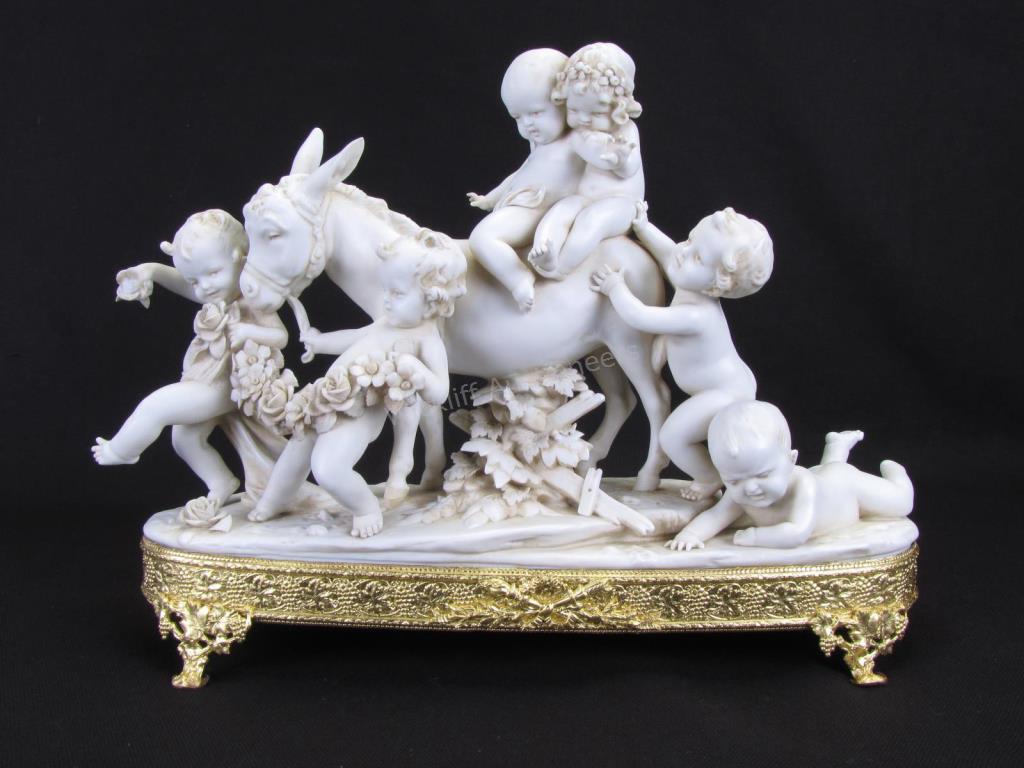 Appraisal: A German bisque porcelain figural grouping depicting putti and mule