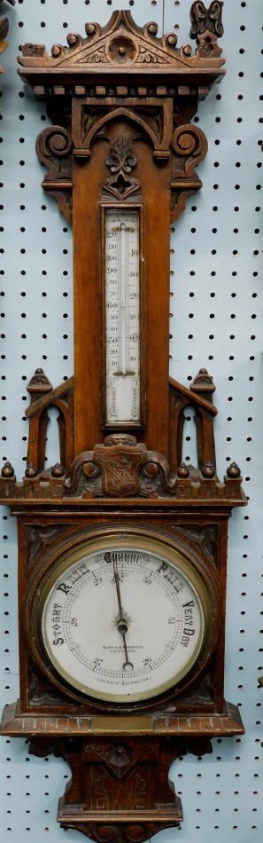 Appraisal: An early thC Gothic carved oak barometer the dial stamped