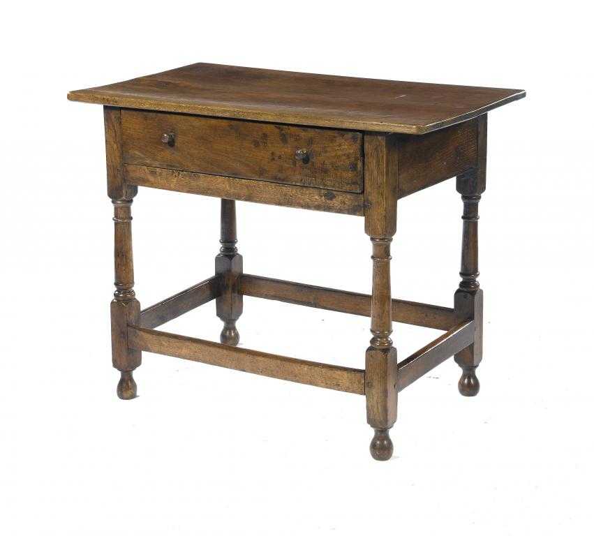 Appraisal: AN OAK SIDE TABLE with oversailing boarded top and drawer