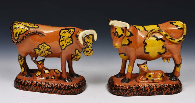 Appraisal: Pair of Staffordshire brown mottled pottery models of cows and