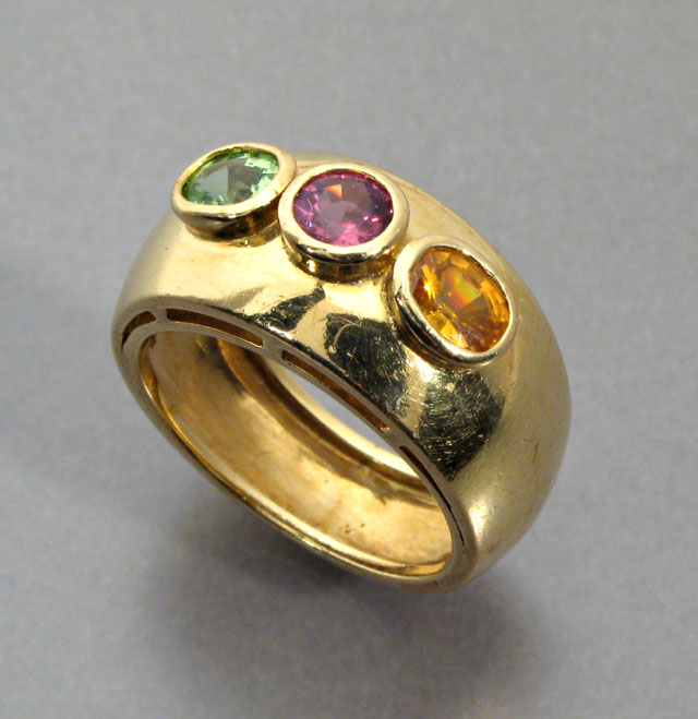 Appraisal: THREE COLOR GEMSTONES AND FOURTEEN KARAT GOLD RING the wide