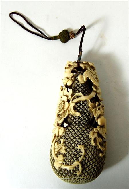 Appraisal: A th century Chinese ivory double gourd pomander in two