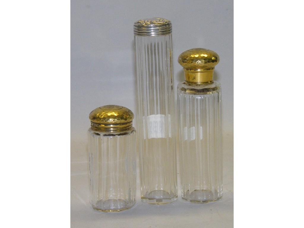 Appraisal: Two different sized Edwardian faceted bottles with silver gilt planished