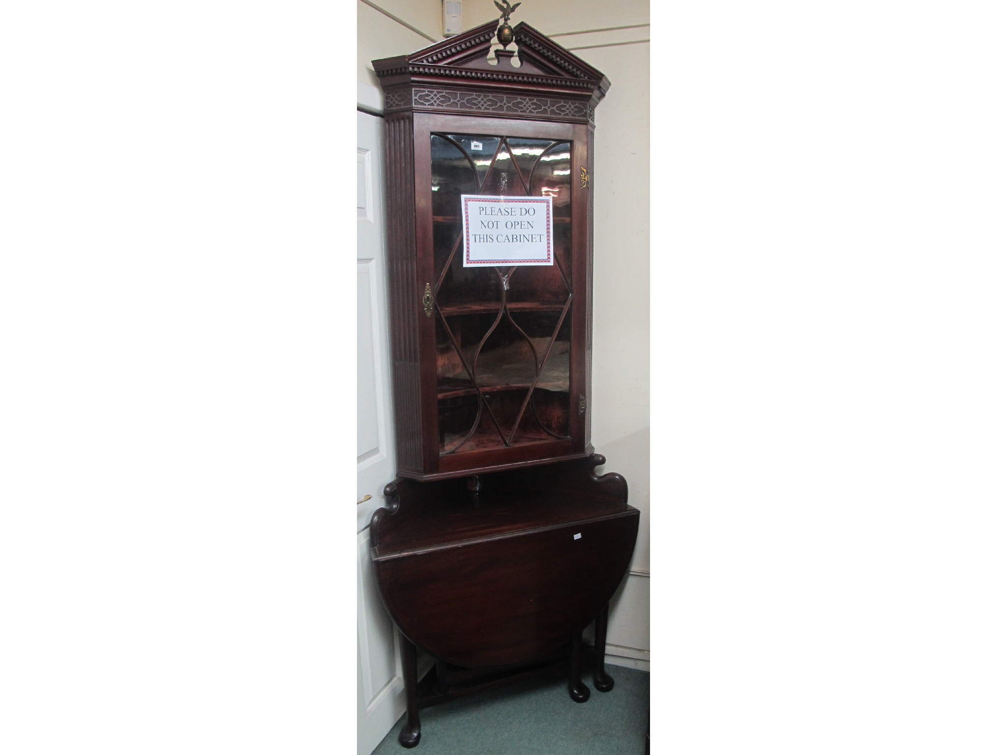 Appraisal: A glazed mahogany corner cabinet with drop leaf table to