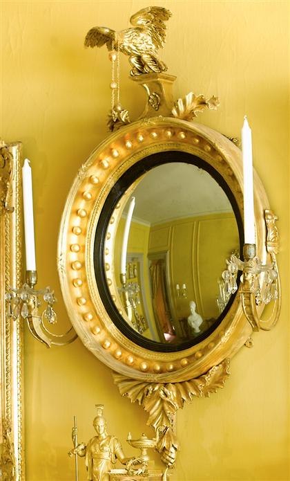 Appraisal: Classical small giltwood girandole convex mirror th century