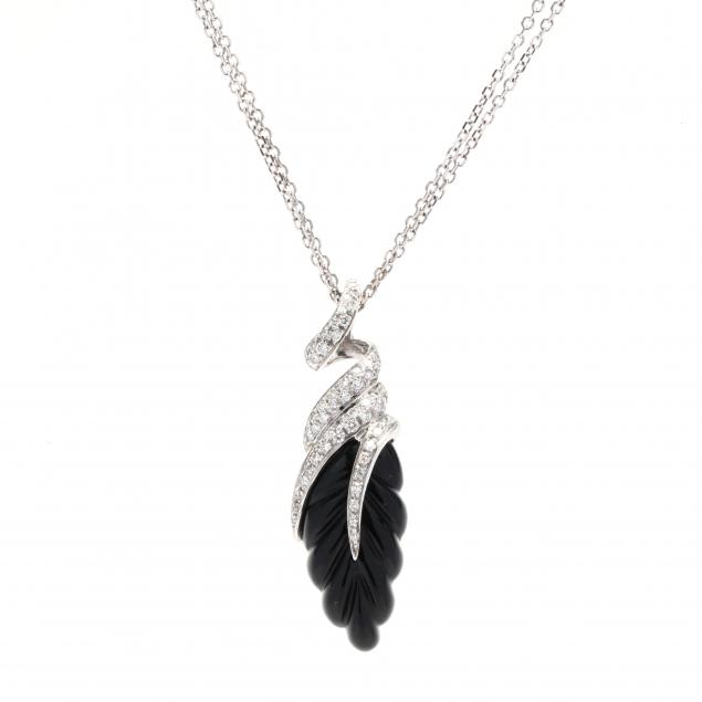 Appraisal: WHITE GOLD DIAMOND AND ONYX NECKLACE The pendant featuring a