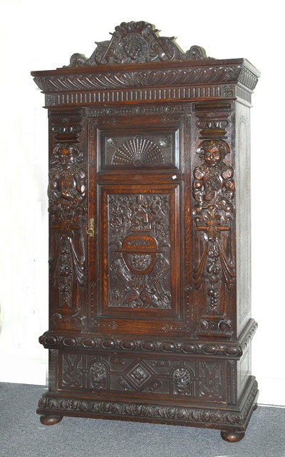 Appraisal: A CONTINENTAL OAK ARMOIRE enclosed by a single door above