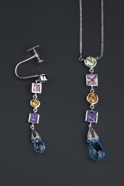 Appraisal: A vari gem-set pendant and matched earring each suspending a