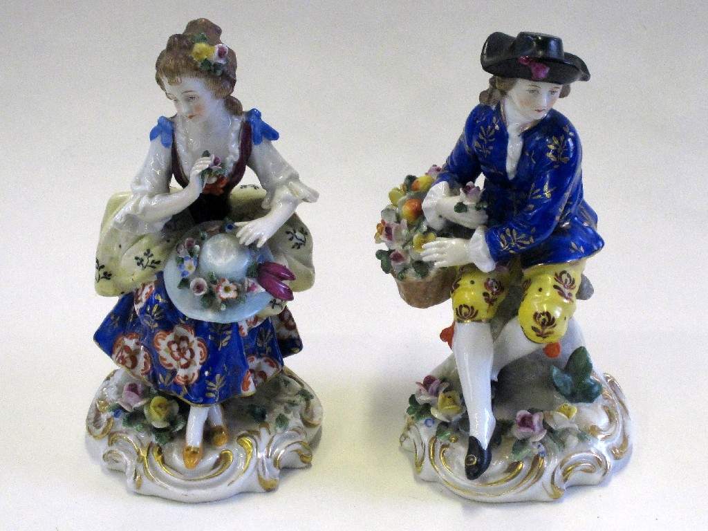 Appraisal: Pair of continental figures of a boy with a basket