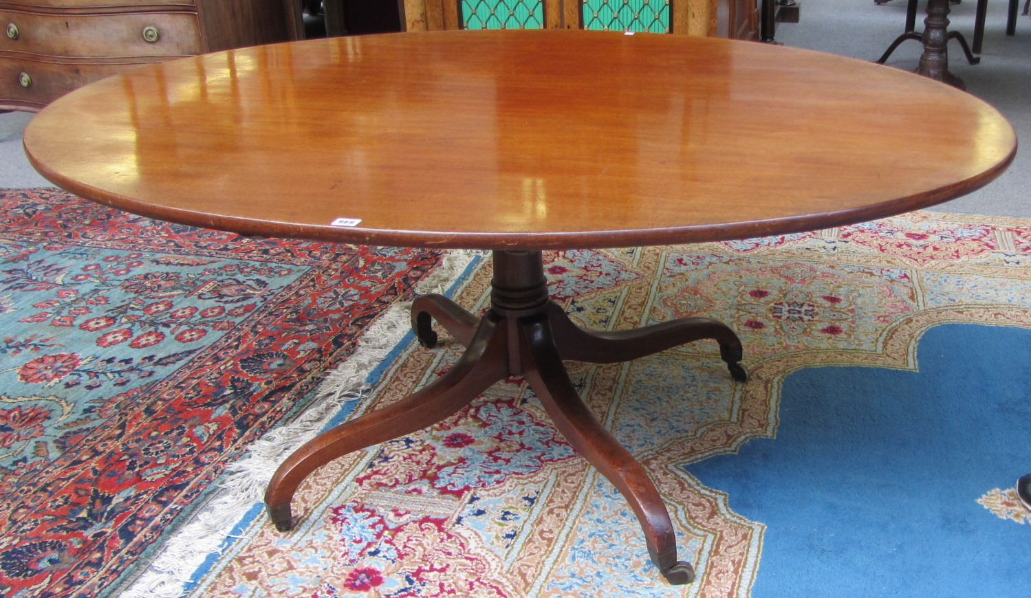 Appraisal: A George III mahogany oval snap top breakfast table on