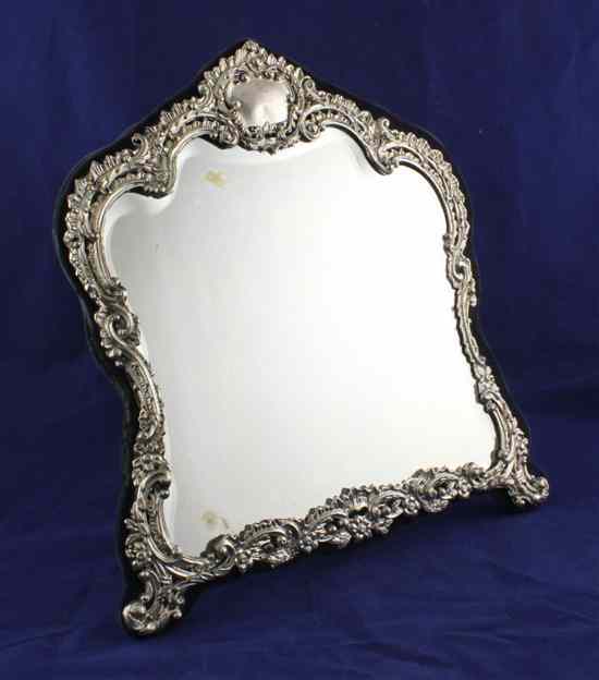 Appraisal: An Edwardian repousse silver mounted easel mirror of domed top