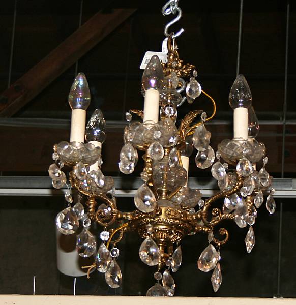 Appraisal: A brass and glass five light chandelier losses height in