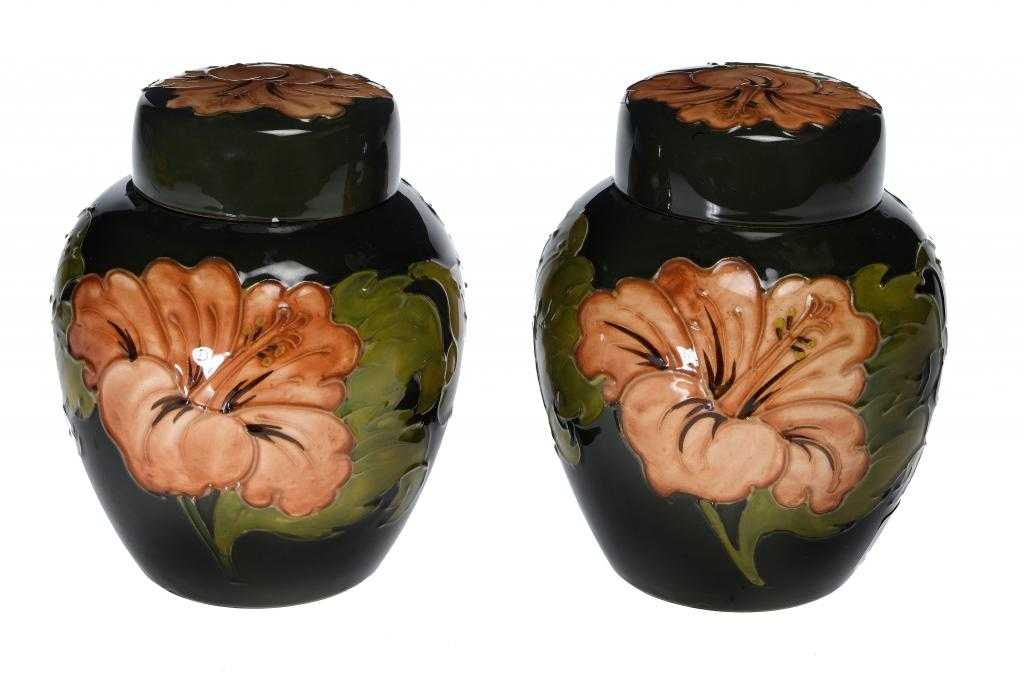 Appraisal: A PAIR OF MOORCROFT HIBISCUS GINGER JARS AND COVERS DESIGNED