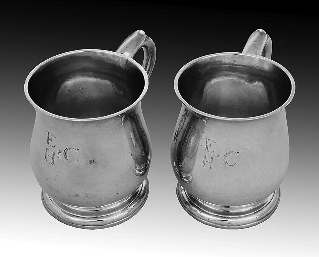 Appraisal: A PAIR OF GEORGE II SILVER TANKARDS baluster shaped with