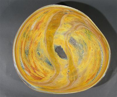 Appraisal: A large Sam Herman glass charger mottled and swirling glass