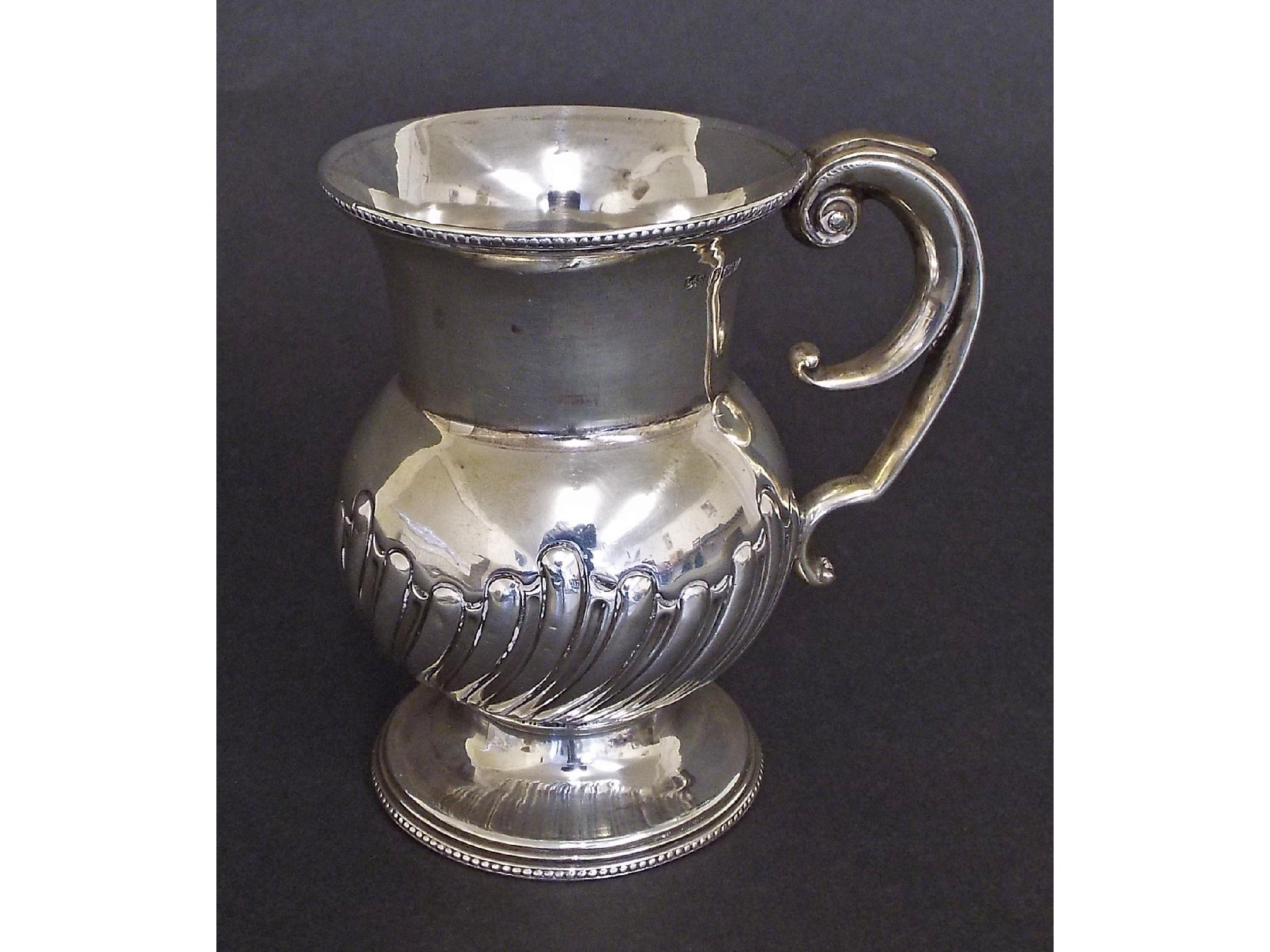 Appraisal: Edwardian silver half wrythen fluted ovoid mug maker Levi Salaman