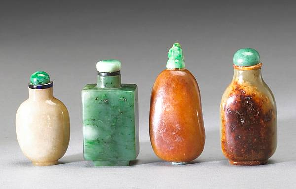 Appraisal: Four jade snuff bottles The first of 'spinach' jade and