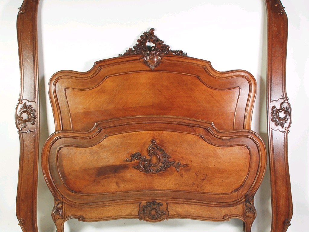 Appraisal: FRENCH BAROQUE STYLE CARVED WALNUT DOUBLE BEDSTEAD the shaped head