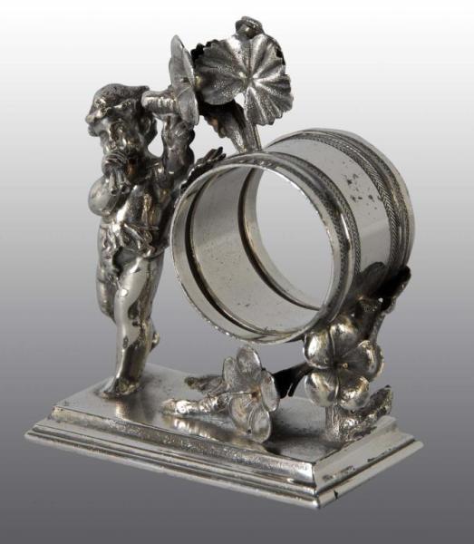 Appraisal: Cherub Playing Instrument Figural Napkin Ring Description Simpson Hall Cherub