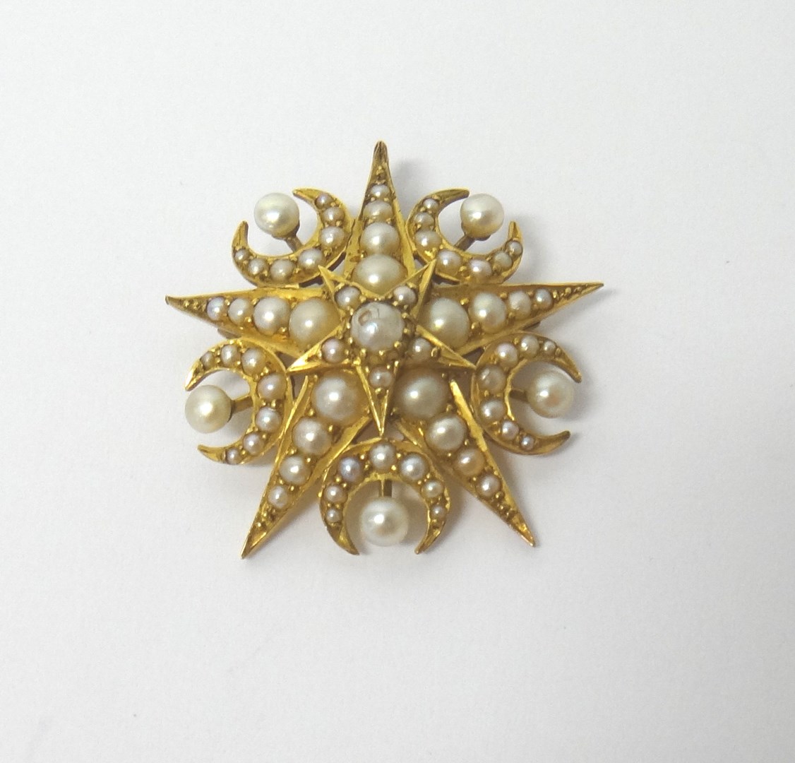 Appraisal: A gold and half pearl set pendant brooch designed as