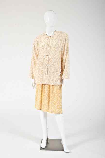 Appraisal: CHANEL SILK BLOUSE AND SKIRT late s Cream tunic-style blouse