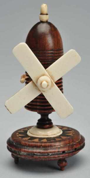 Appraisal: Windmill Figural Tape Measure Description Inlaid wood The celluloid windmill