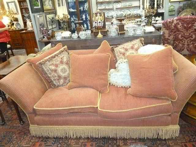 Appraisal: A KNOLE TYPE SOFA with carved parcel gilt pine cone