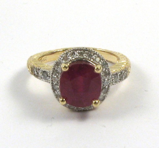 Appraisal: RUBY DIAMOND AND FOURTEEN KARAT GOLD RING centering an oval-cut