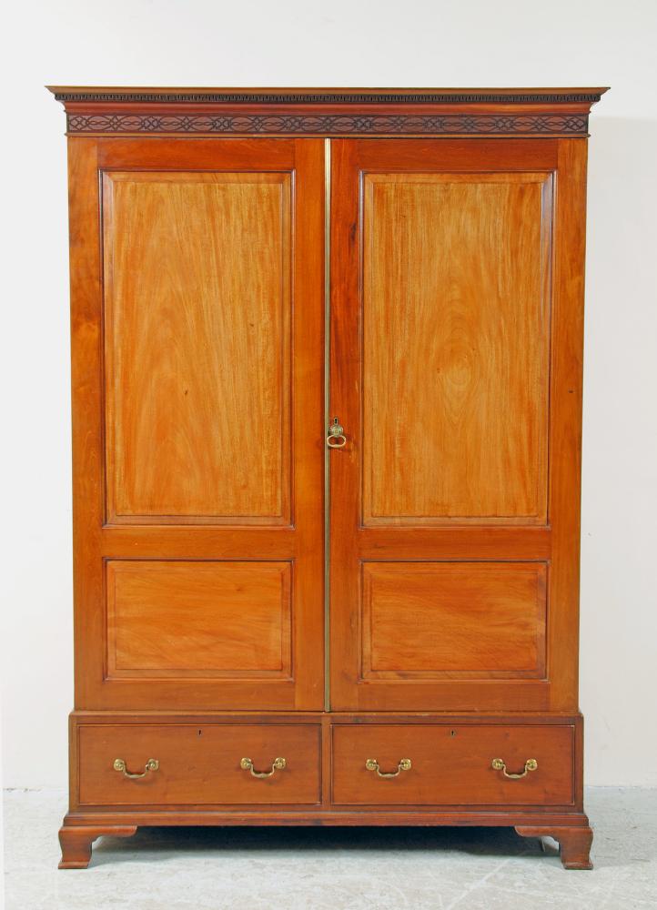 Appraisal: A MAHOGANY WARDROBE th century the dentil moulded cornice over