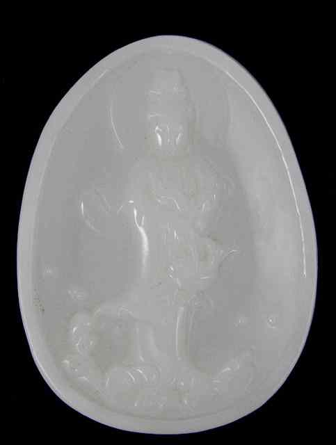 Appraisal: A Chinese pale celadon jade oval plaque carved with the