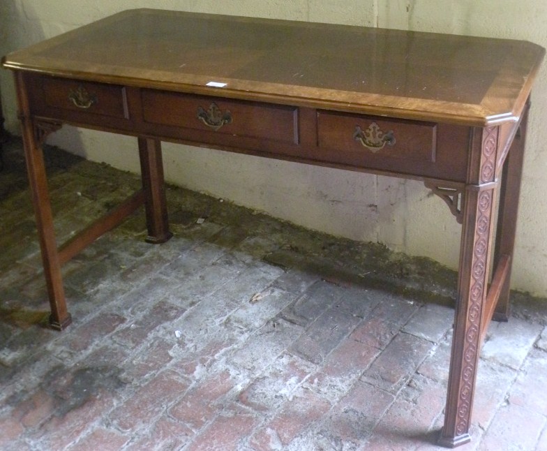 Appraisal: A thC walnut and mahogany finish Chippendale design side table