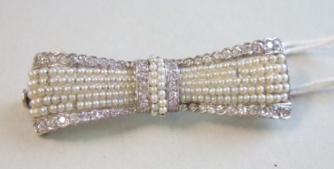 Appraisal: A diamond and seed pearl brooch designed as a bow