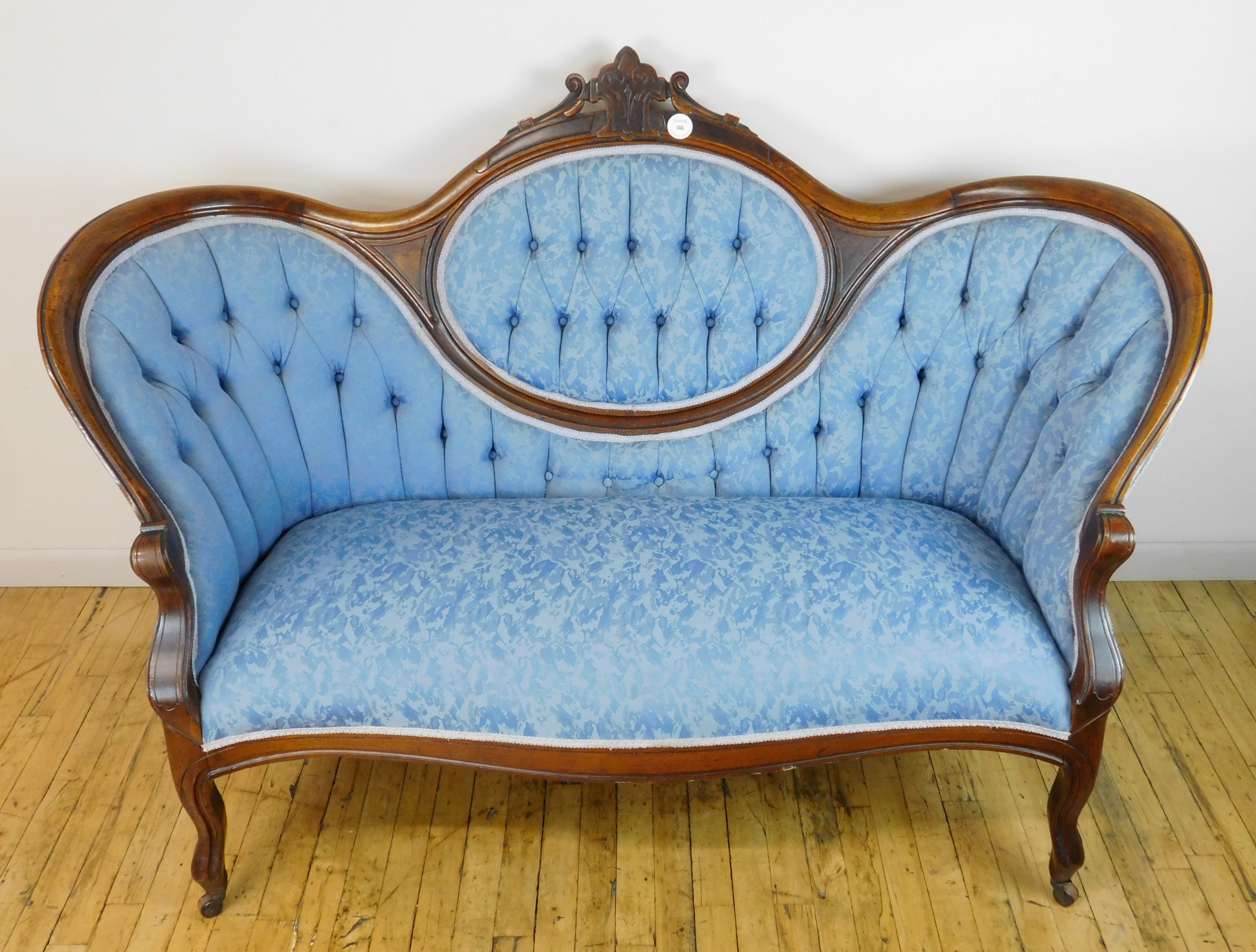 Appraisal: Victorian love seat covered in light blue upholstery good condition