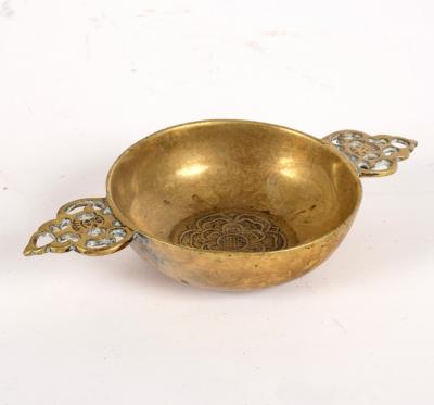 Appraisal: A small brass porringer with pierced foliate handles and central